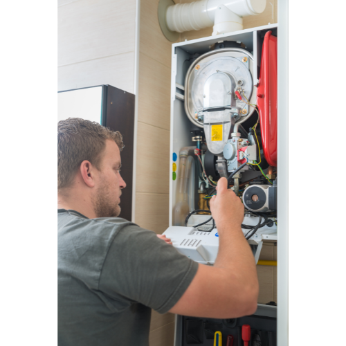 hvac tech working on furnace